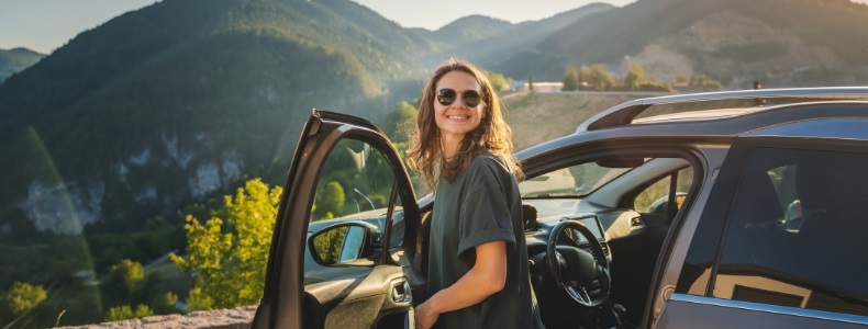 Woman getting out of a car on a mountain overlook mobile