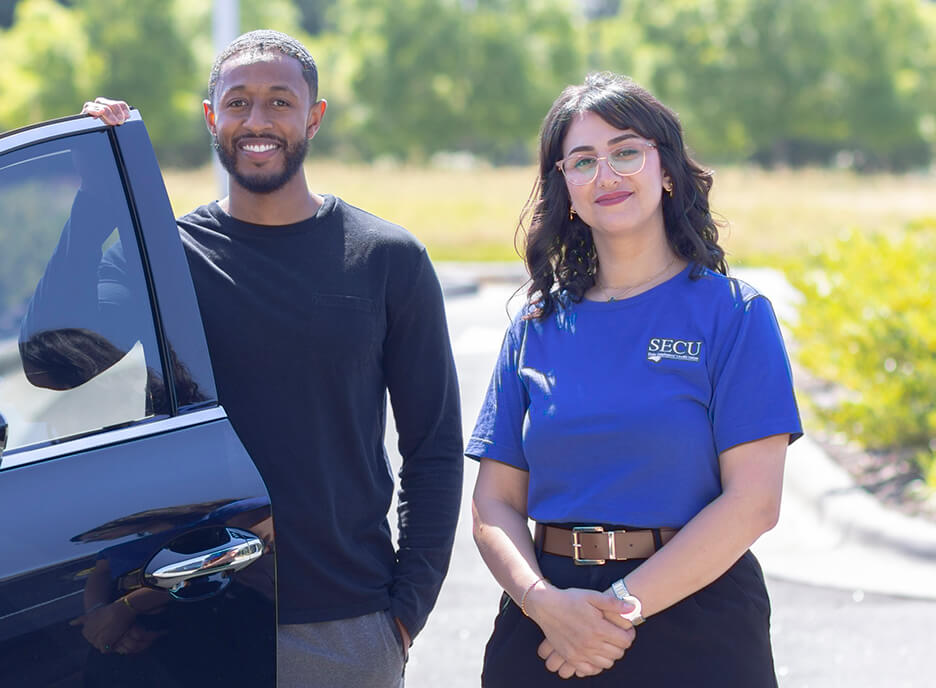 SECU Employee and a member standing next to a new car