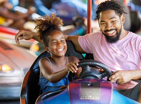 Father and Daughter riding bumper cars