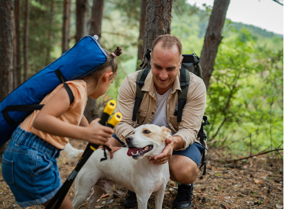 Father and Daughter camping with dog