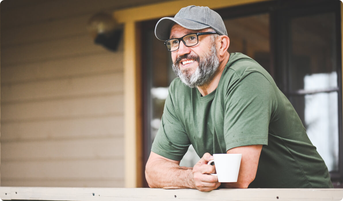 Man with coffee on porch