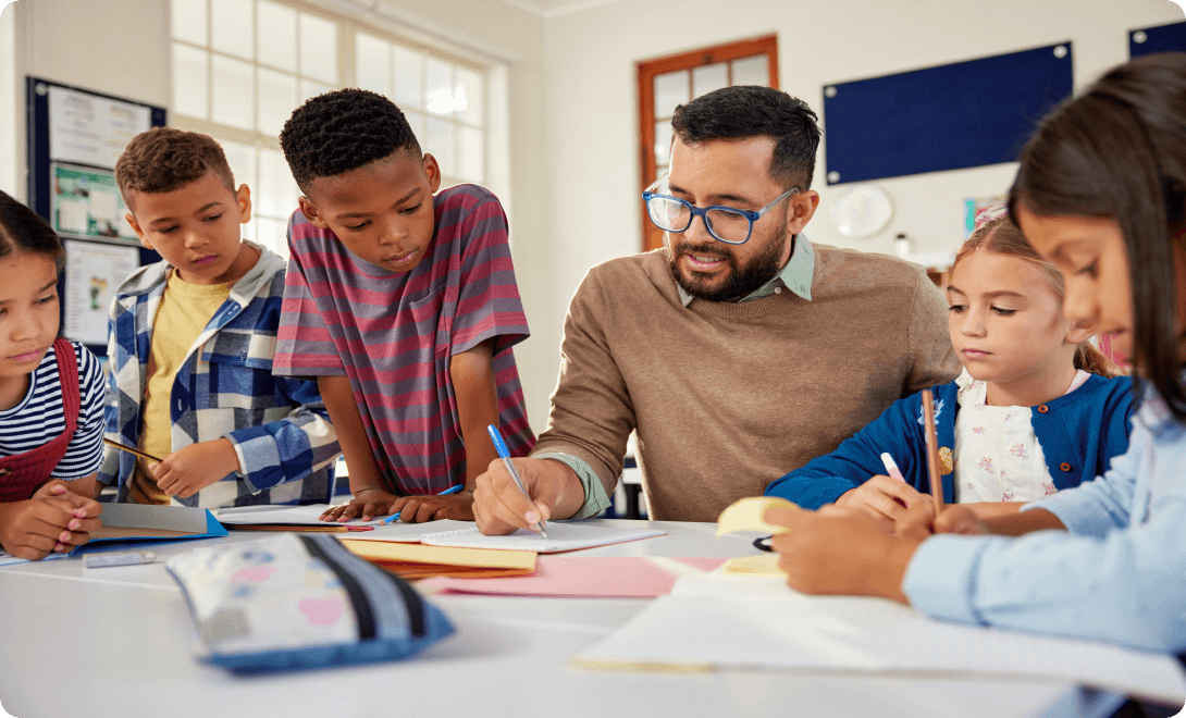 Teacher showing students something with pencil and paper