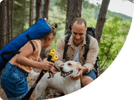 Father and Daughter hiking with dog