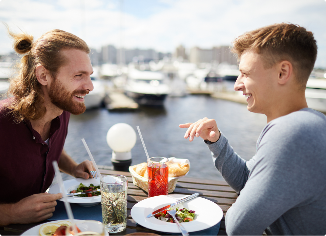 Two men eating outside