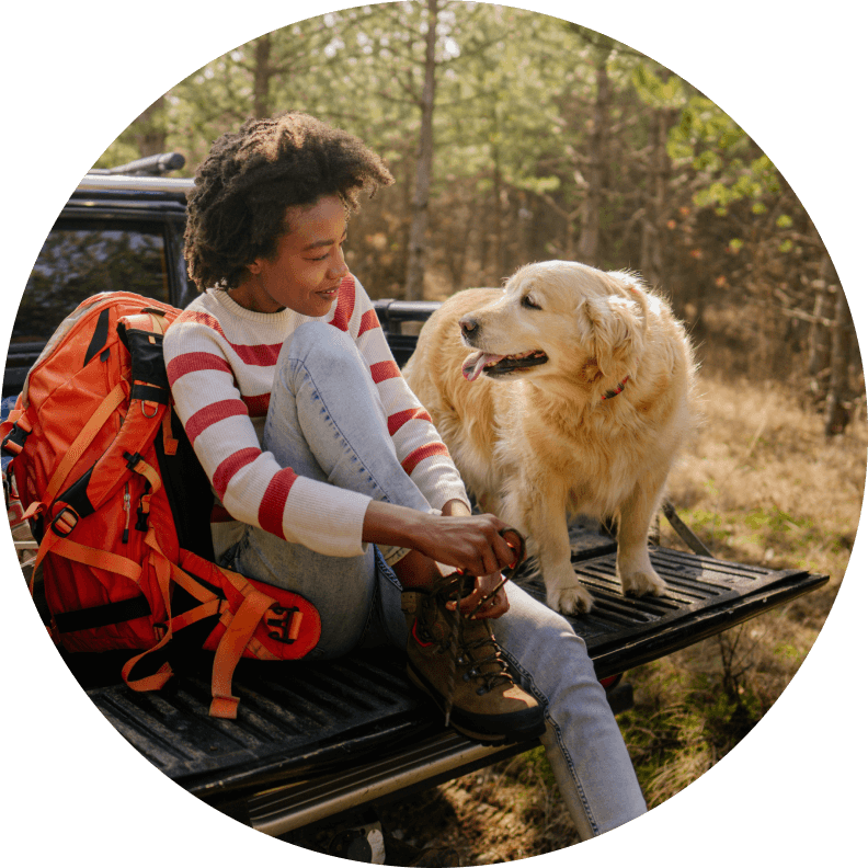 Girl with dog on back of truck
