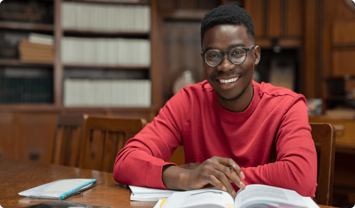 college boy at desk with book