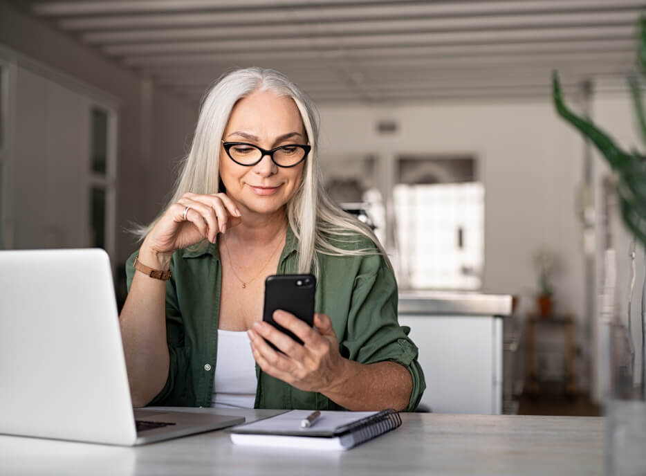 Woman with glasses looking at phone