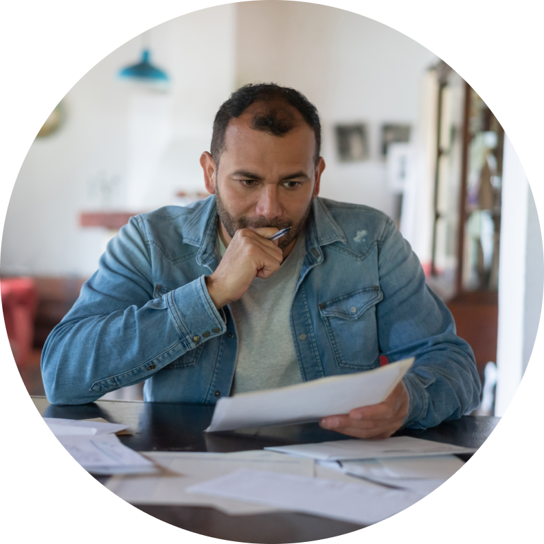 Man looking at paperwork at table