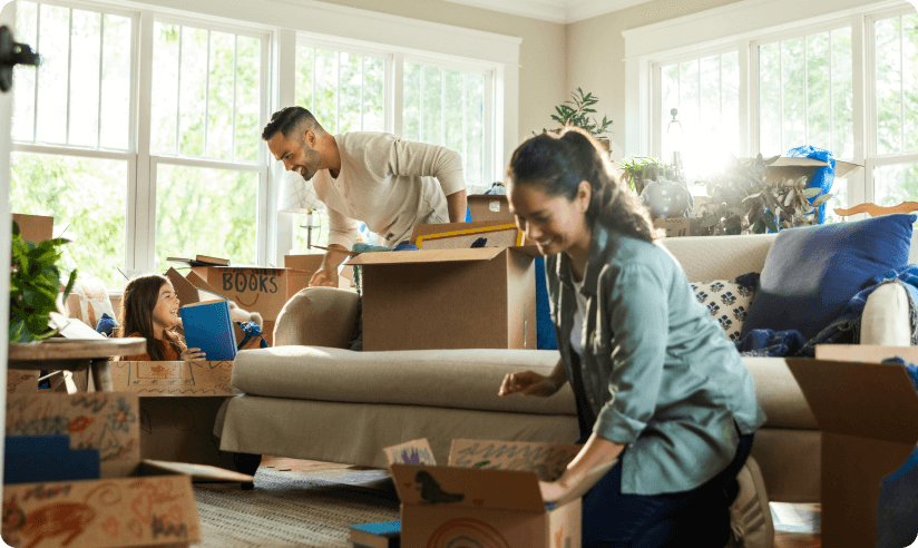 Man and woman moving boxes into a new home