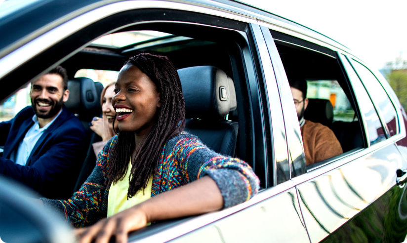 Group of happy people sitting in a car