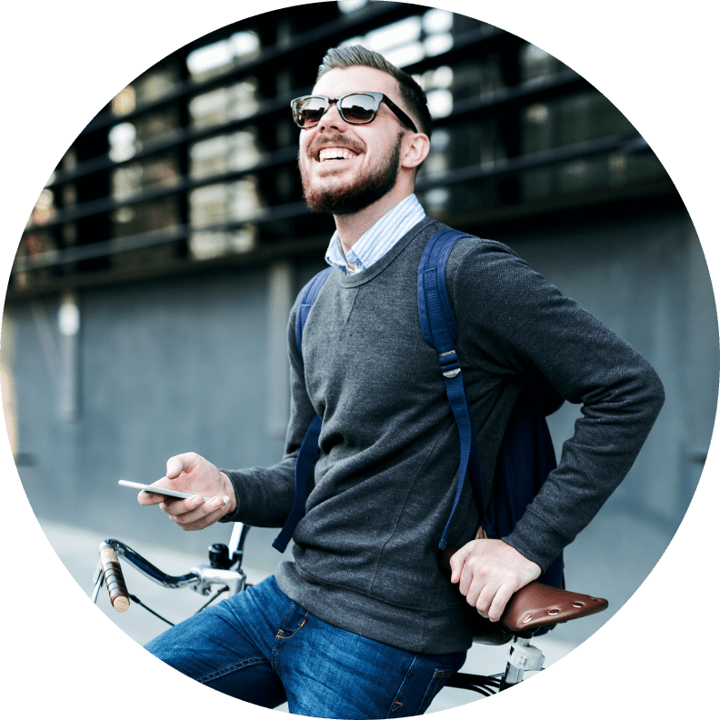 man sitting on bike with cell phone