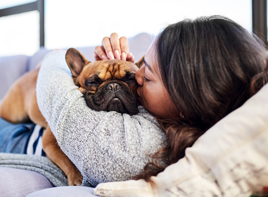 Girl laying on couch with dog