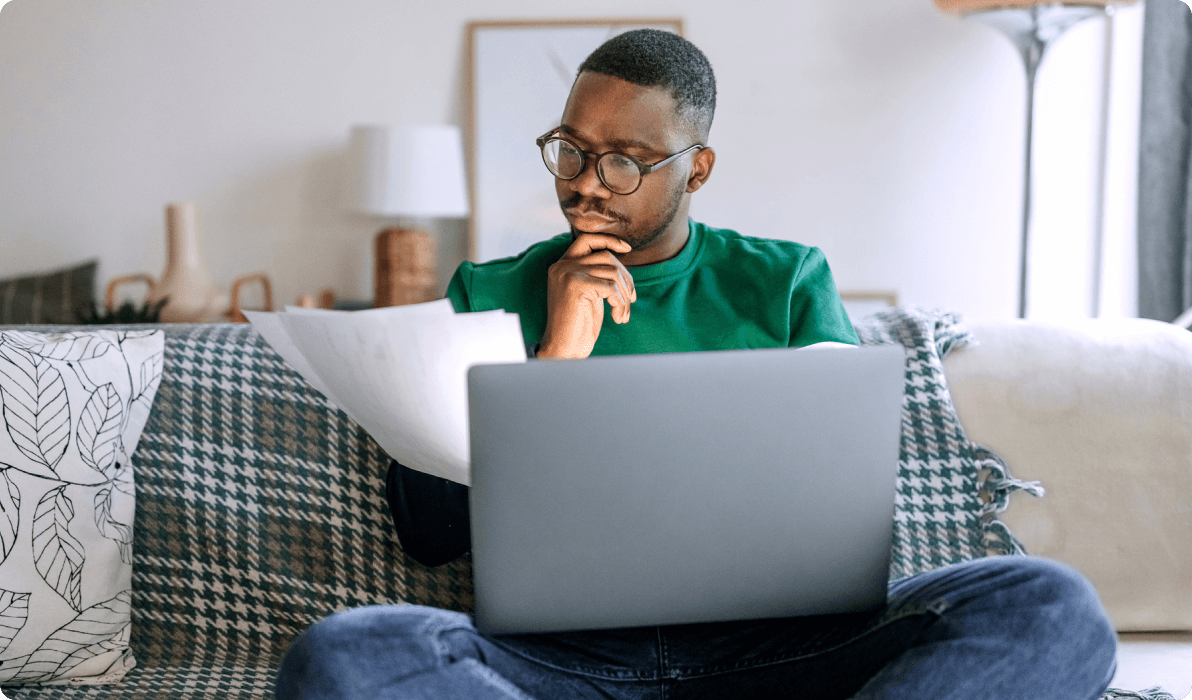 Young man on couch using laptop