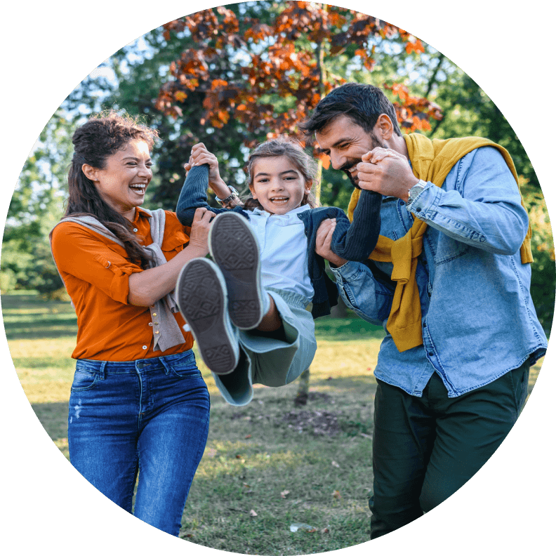 Mother and father swinging child