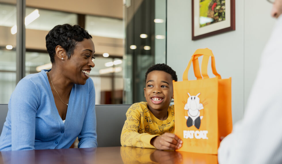 Boy and mother opening a FAT CAT account