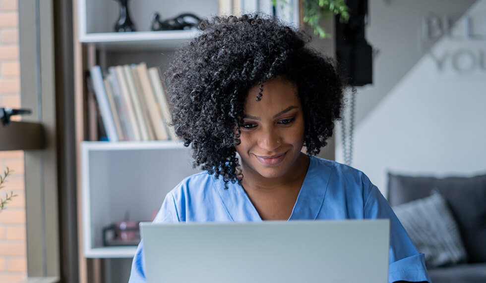 Guide to Credit Reports woman with curly hair using laptop