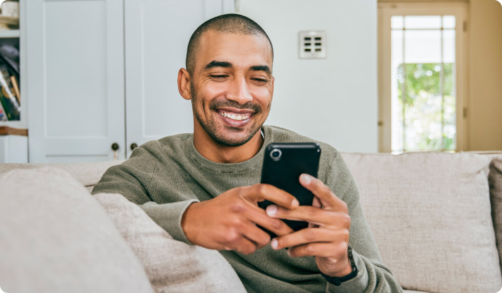 man smiling at phone